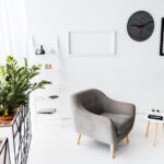 modern interior of waiting hall with grey armchairs and plants